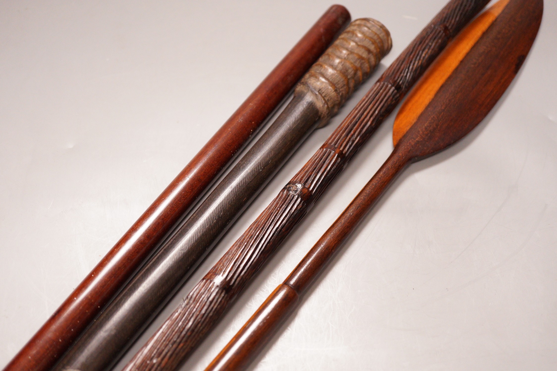 Two various hardwood canes, an ebony spear and a horn tool, longest 111cm